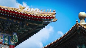 Time lapse of ancient chinese roof with bells under eaves sway on wind, water drops faling from eaves bright blue sky and white cumulus clouds in background. Side view of traditional pagoda tiled roof - Powered by Shutterstock - Get 15% off with code: PIKWIZARD15