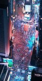 Vertical Screen: New York City Night Aerial Landscape with Manhattan Skyscrapers and Crowded Times Square Tourist Landmark. Drone View with Edited Custom Billboards and Commercials with Neon Lights