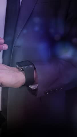 Man works with smartwatch and virtual infographics.
