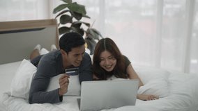 Young couple use laptop in bedroom. Lifestyle and couple. - Powered by Shutterstock - Get 15% off with code: PIKWIZARD15