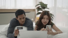 Young couple use laptop in bedroom. Lifestyle and couple. - Powered by Shutterstock - Get 15% off with code: PIKWIZARD15