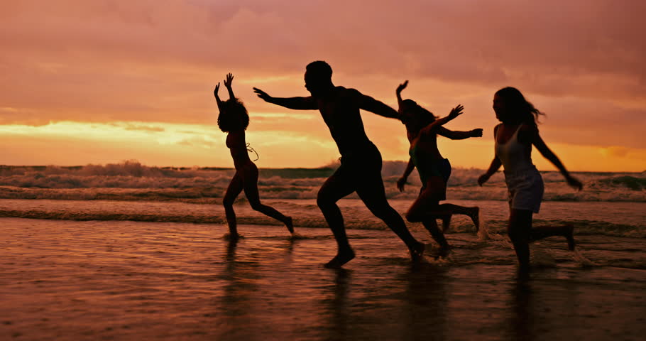 Silhouette, ocean and friends running at sunset for summer vacation, holiday and travel together outdoor. Beach, dusk and group of people at sea water for adventure, party and having fun in nature Royalty-Free Stock Footage #3454477941