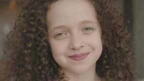 Close-up Portrait of Happy Little Child girl Bursting in Laugh. Kid female Laughs Indoors Closeup. Portrait of Little Child Looking and Smiling to Camera. Face Funny Contemplative Kid. Slow Motion. - Powered by Shutterstock - Get 15% off with code: PIKWIZARD15