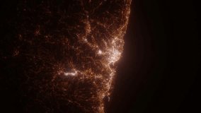 Genoa (Italy) top view at night. Aerial view on modern city with lights. Camera is flying above the city, moving backward. Vertical video. The north is on the left side