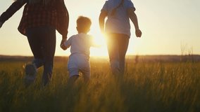 family runs across the field. happy childhood concept for little child. big happy family running across field on the grass holding hands, sunset on lifestyle the background, silhouettes - Powered by Shutterstock - Get 15% off with code: PIKWIZARD15