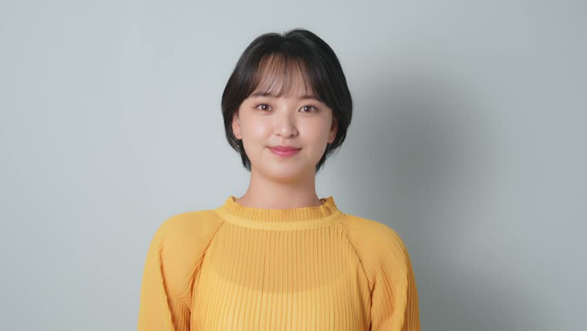 A smiling woman wearing colorful clothes.