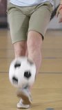 Football freestyle. Young man practices with soccer ball. Vertical video