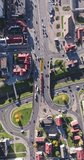vertical accelerated aerial video above road junction with heavy traffic on bridge