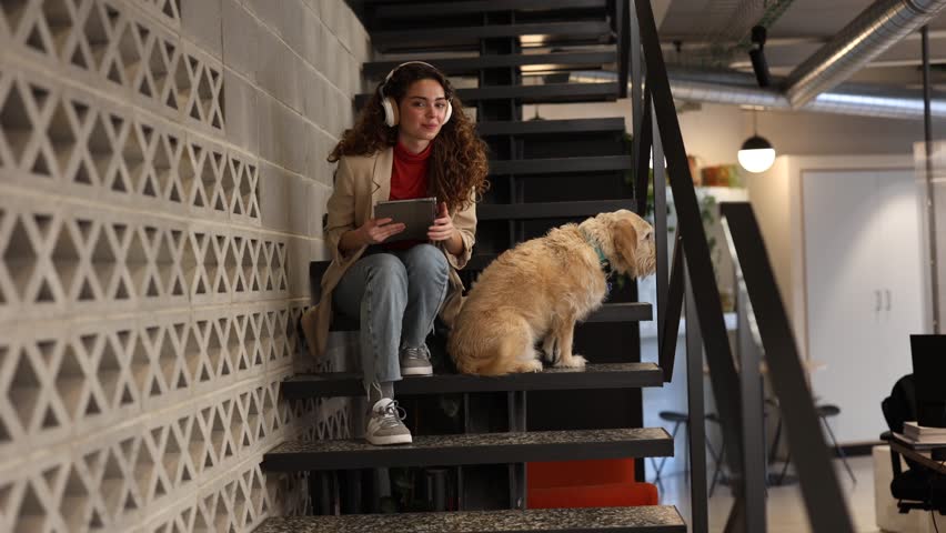 woman working in office pet friendly going down the stairs