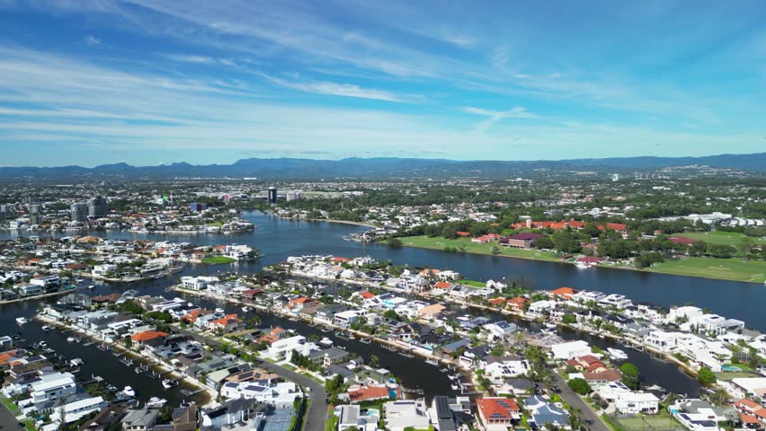 Aerial view of the urban city sprawl along the Nerang River and Gold Coast Highway. drone view