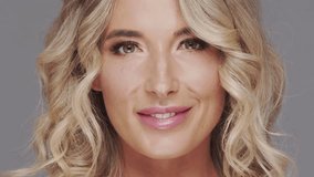 Studio portrait of young and beautiful blond woman over grey background. Skin care and wellness concepts. - Powered by Shutterstock - Get 15% off with code: PIKWIZARD15