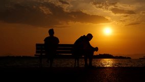 Couple during difficult times. A view of man and woman silhouette sitting back to back and suffer from divorce time in the family on evening bench. - Powered by Shutterstock - Get 15% off with code: PIKWIZARD15