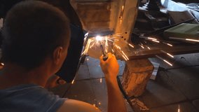 Repairer wearing protective mask welding some detail of auto. Mechanic working in garage or workshop. Man engaged servicing vehicles. Bright sparks flying around in dark. Car repair concept. Back view - Powered by Shutterstock - Get 15% off with code: PIKWIZARD15