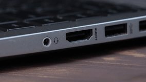 Man is insert the cable HDMI into the Port for information transfer. 