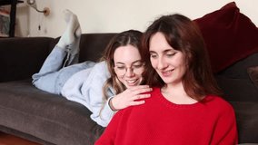Female gay couple lie on the sofa conducting research on a laptop in their living room. Two lesbian women recline on the sofa, engaged in researching on a laptop in their living room. - Powered by Shutterstock - Get 15% off with code: PIKWIZARD15