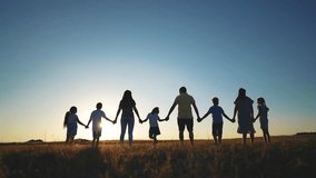 big family. huge community family holding hands walking in the park sunset. happy family kid dream concept. big family community walking with children in the park. friendly people sunlight walking - Powered by Shutterstock - Get 15% off with code: PIKWIZARD15