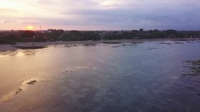 Aerial view drone footage of sanur beach bali during sunset, flying over water, fly above water