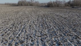 Frozen Tilled Soil of a Farmland with Sparse Snow Cover, Aerial - Powered by Shutterstock - Get 15% off with code: PIKWIZARD15