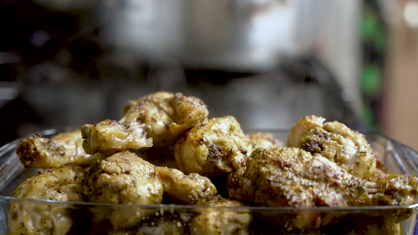 The sight of steam rising off freshly cooked chicken meat, showcased in a close-up bowl shot, evokes the anticipation of delicious food preparation.
