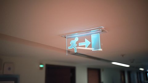 Emergency Exit sign symbol man with right arrow in hospital corridor