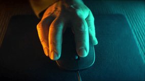 Hand moving mouse, click with your fingers and move the wheel. Neon, green and orange lights illuminate the image from side to side. Cyberpunk effect. - Powered by Shutterstock - Get 15% off with code: PIKWIZARD15