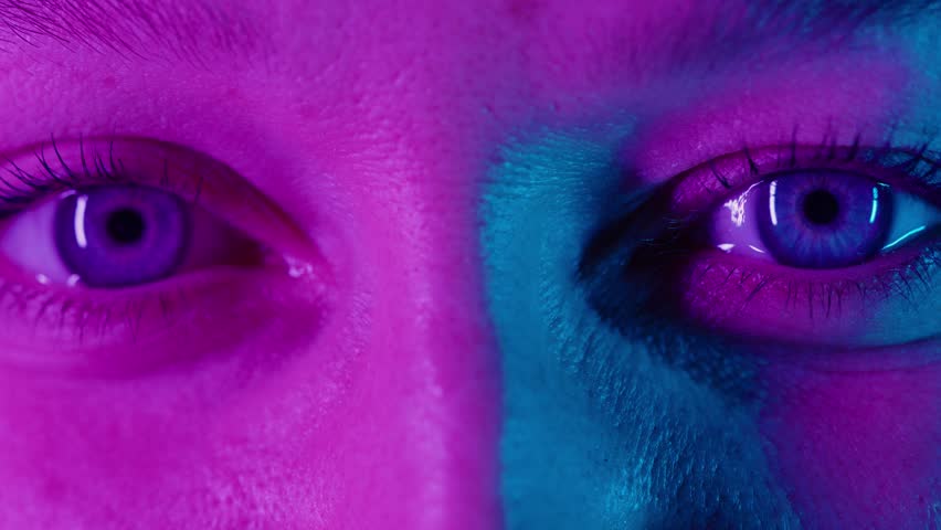 Eyes cry in violet-blue light. Women