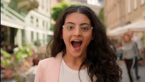 Young surprised amazed excited woman Indian Arabian female girl outside. Positive businesswoman shock smiling open mouth town street win gesture sincere happy delight emotion astonishment announcement - Powered by Shutterstock - Get 15% off with code: PIKWIZARD15