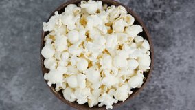 Fresh popcorn snacks in a wooden bowl spinning. - Powered by Shutterstock - Get 15% off with code: PIKWIZARD15