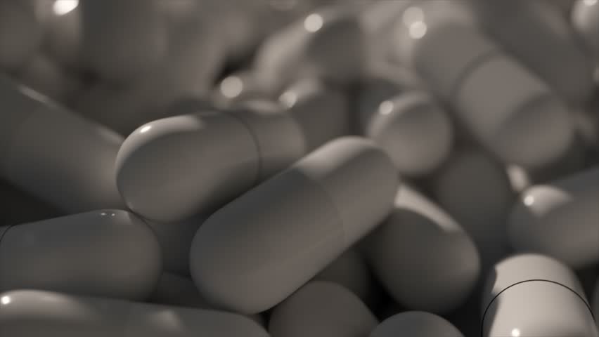 Monochromatic pile of capsules with a matte finish, suitable for grayscale medical animation. Royalty-Free Stock Footage #3454997405