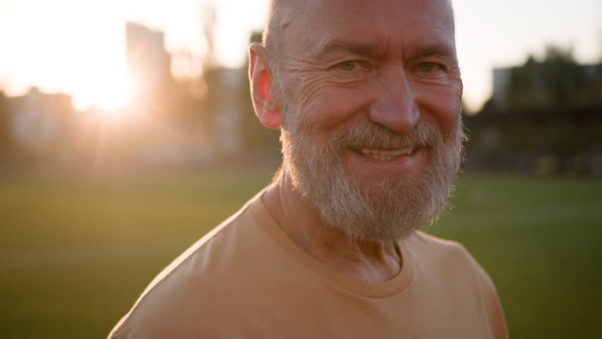 Close up portrait Caucasian old gray-haired man looking at camera happy pensioner smiling toothy dental smile fun enjoy healthy wellness stadium sportsman sport outside city retirement satisfied male - Powered by Shutterstock - Get 15% off with code: PIKWIZARD15