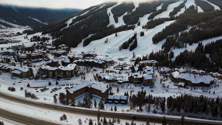 Copper Mountain Colorado ski resort foggy cloud layer winter snowy early morning sunrise aerial drone i70 Eagle Flyer lift center village half pipe Ikon pass snowboarding forward slowly pan upward