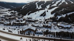 Copper Mountain Colorado ski resort foggy cloud layer winter snowy early morning sunrise aerial drone i70 Eagle Flyer lift center village half pipe Ikon pass snowboarding forward slowly pan upward - Powered by Shutterstock - Get 15% off with code: PIKWIZARD15