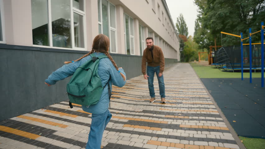 Daughter running to father. Happy family man lift girl primary school outside after lessons educational hug embrace cuddle candid childcare parenting relationship love emotions greeting meet together - Powered by Shutterstock - Get 15% off with code: PIKWIZARD15