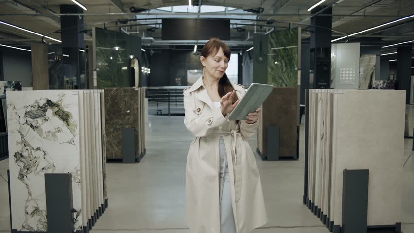 Woman with tablet in tile showroom