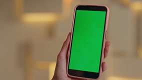 Unrecognizable woman surfing internet at green screen smartphone in modern office close up. Female hands scrolling chroma key cellphone. Unknown businesswoman reading message on mockup mobile phone. - Powered by Shutterstock - Get 15% off with code: PIKWIZARD15