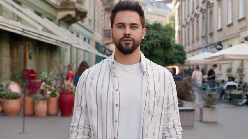 Young European Caucasian man gesture hand stop denial turn head no negative answer refusal guy city outside forbidden restriction sign rejection serious disagree dislike expression unpleasant privacy