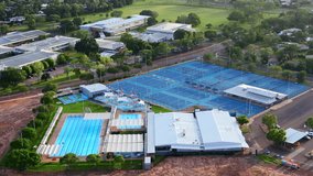 Aerial drone of Recreational Swimming Pool and Tennis Courts at Golden Hour in Moulden Northern Territory Australia - Powered by Shutterstock - Get 15% off with code: PIKWIZARD15