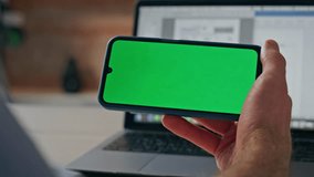 Businessman hand holding mockup cell display indoors. Closeup unknown formal boss using chroma screen smartphone. Anonymous ceo watching horizontal green mobile phone online. Communication concept  - Powered by Shutterstock - Get 15% off with code: PIKWIZARD15