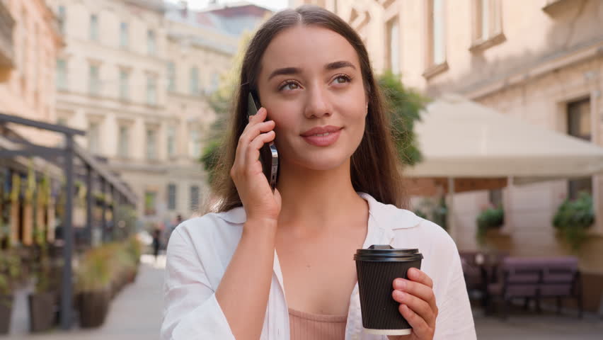 Close up Caucasian European joyful woman talking mobile phone smartphone chatting laughing smiling fun drinking coffee in city street cafe outdoors urban cheerful lady model girl happy businesswoman Royalty-Free Stock Footage #3455066175