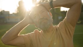 Close up Caucasian European pensioner stretch neck muscles head sporty elderly man warm-up flexibility elastic sunrise stadium outdoors city morning training physical activity practicing healthcare - Powered by Shutterstock - Get 15% off with code: PIKWIZARD15