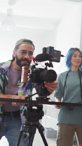 Vertical Screen: Slow Motion of Creative Crew Working Together on the Shooting of a Creative Musical Video: Young Film Industry Workers Preparing Video Content for a Client, Using Modern Technology