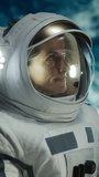 Vertical Screen: Portrait of a Female Astronaut Wearing Helmet and Suit in Outer Space, Floating in Zero Gravity and Looking at Camera in Wonder. Space Travel, Solar System Exploration Concept