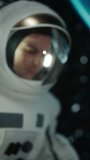 Vertical Screen: Male Space Explorer Travelling in Space, Discovering the Depths of Our Universe. Close Up Face Footage of an Young Adult Man in a Helmet Amazed by the View on Planet Earth from Space