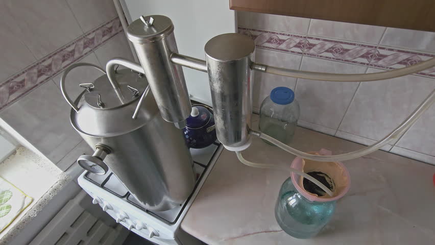 Domestic amateur distillation equipment for the distillation of moonshine alcohol, close-up with selective focus.