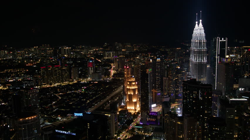 vibrant night scene of Kuala Lumpur, showcasing the city