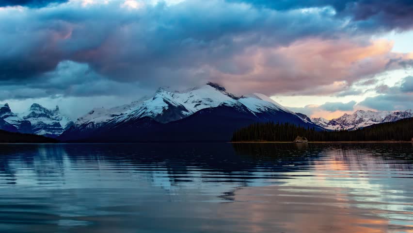 Glacier lake in Canadian Mountain Landscape. Dramatic Sunset. Maligne Lake, Jasper, Alberta, Canada. Cinemagraph Continuous Loop Animation.