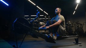 African American man sporty male strong guy fitness athlete sportsman fit workout on training simulator in gym sport exercising on rowing machine bodybuilder doing low row of rope pulleys sitting - Powered by Shutterstock - Get 15% off with code: PIKWIZARD15