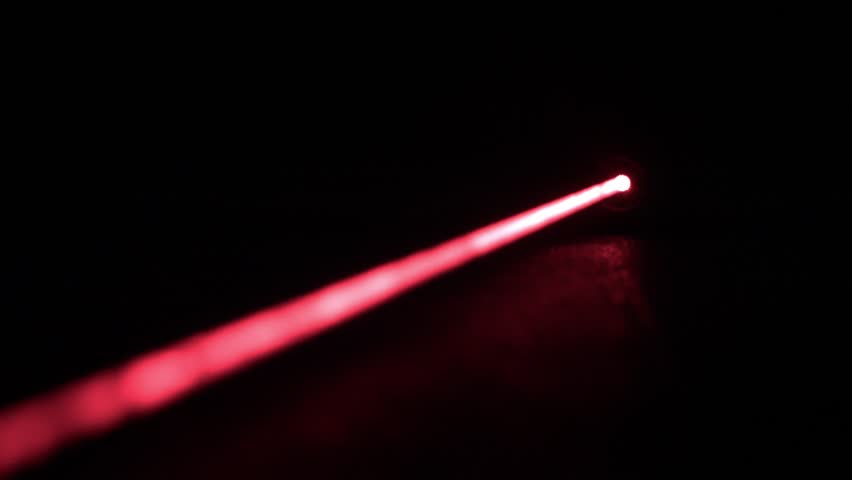 Long Red Laser Beam from Laser Pointer, Rack Focus, Black Background