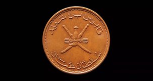 Obverse of Oman coin 10 baisa 2008, isolated in black background. Seamless animation in 4k resolution video.
