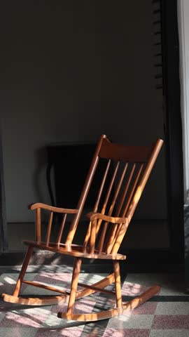 The rocking chair rocks or moves in the room. 